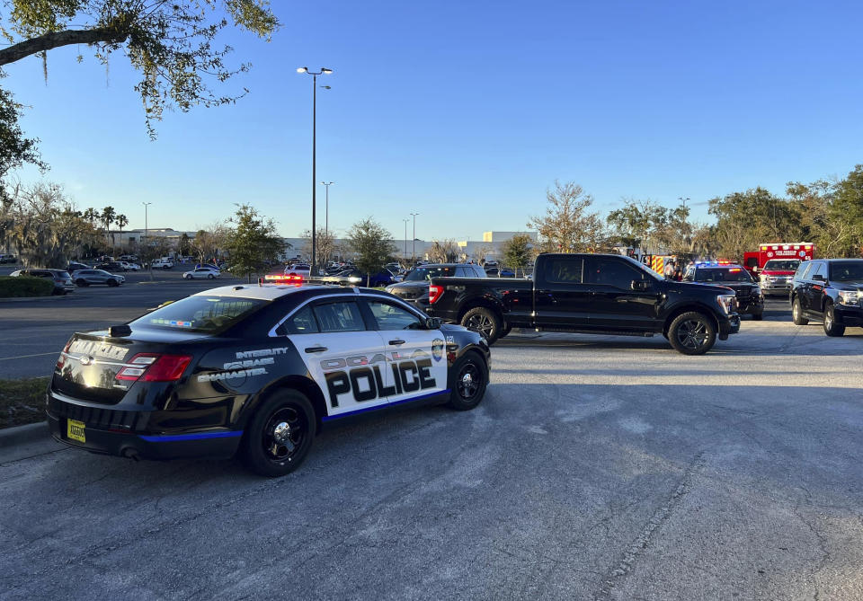 In this photo provided by the Ocala Police Department, a cruiser sits parked following a fatal shooting at Paddock Mall in Ocala, Fla., located about 80 miles northwest of Orlando, Saturday, Dec. 23, 2023. (Jeff Walczak/Ocala Police Department via AP)