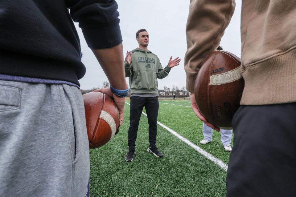 Former Smyrna High and University of Delaware quarterback Nolan Henderson (Center) recaps practice, after a quarterbacks training session on Sunday, February 11, 2024 at the Red Lion Christian Academy turf field in Bear.