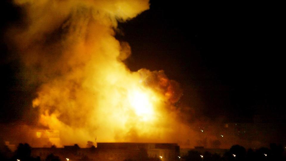 A government building burns during heavy bombardment of Baghdad, Iraq, by U.S.-led forces in this March 21, 2003 file photo. 