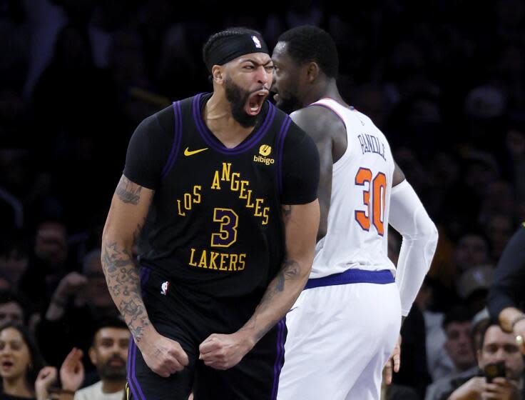 Los Angeles, CA - December 18: Lakers forward Anthony Davis, #3, left, celebrates his fourth.