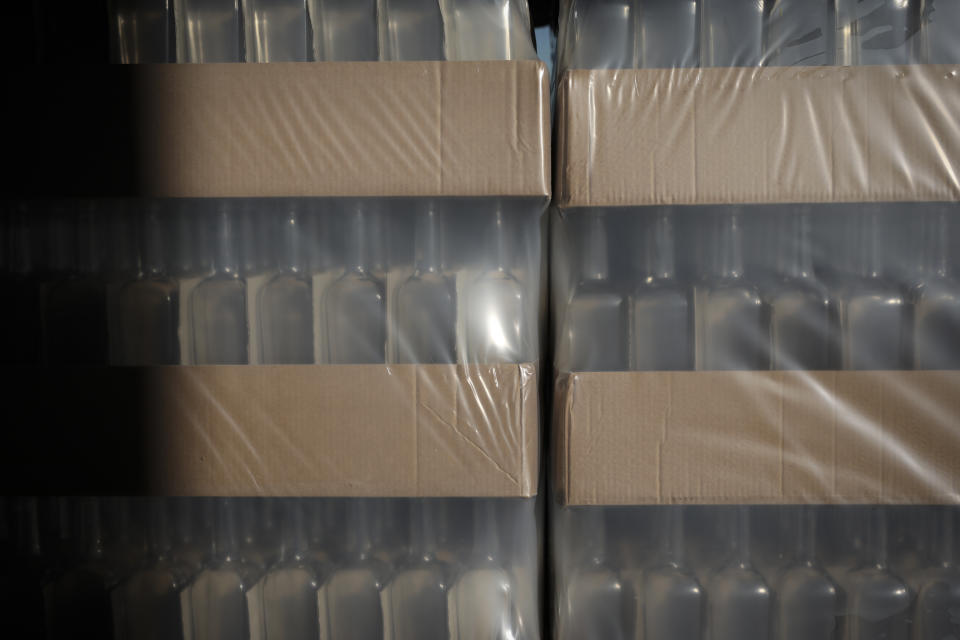 Empty wine bottles sit in a warehouse in Le Cannet-des-Maures, in the Provence region, Thursday Oct. 10, 2019. European producers of premium specialty agricultural products like those protected at home for their territorial origin and sometimes centuries of artisanal know-how that fetch premium prices like French wine, are facing a U.S. tariff hike on Friday, dragged into a trade war over the fiercely competitive aerospace industry.(AP Photo/Daniel Cole)