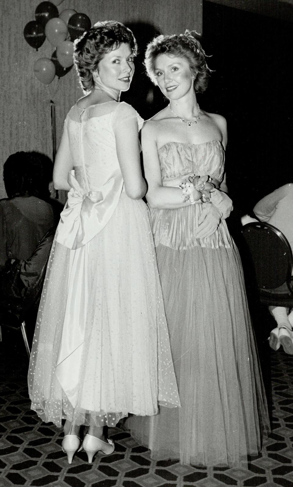 Identical twins Colleen Stanczuk and Maureen Waterworth wearing prom dresses in 1984