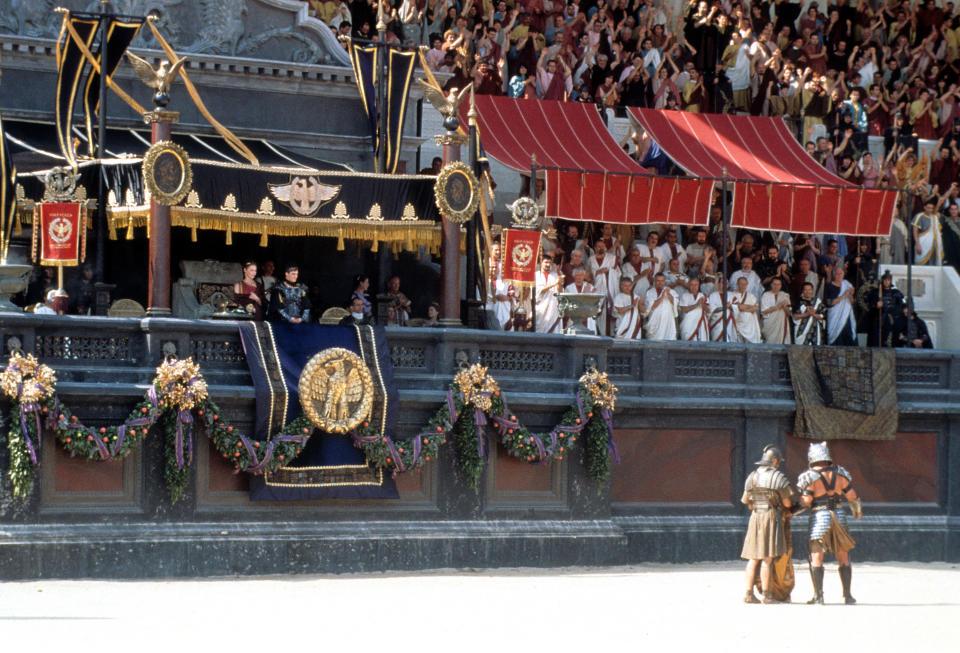 Connie Nielsen and Joaquin Phoenix looking with crowd out over the gladiatorial arena in a scene from the film 'Gladiator', 2000. (Photo by Universal/Getty Images)