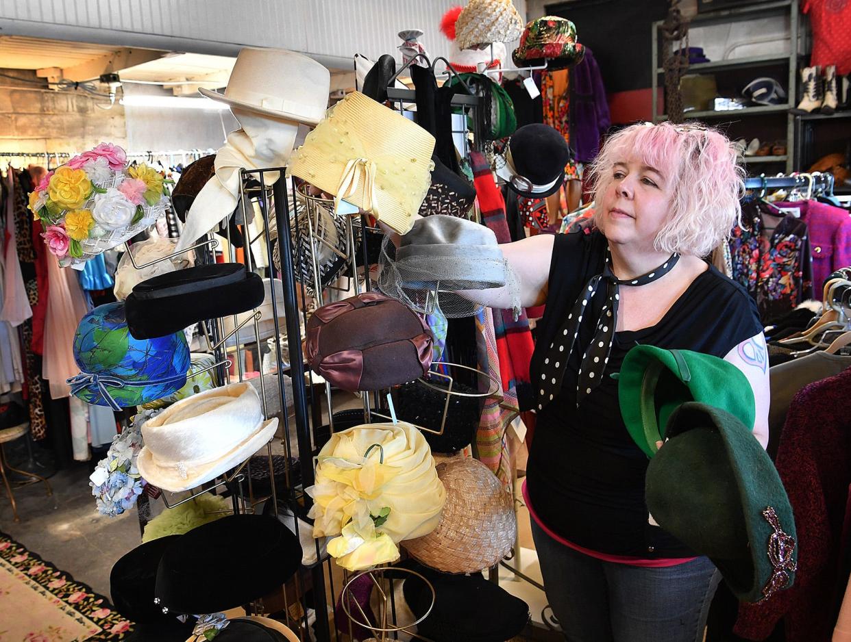 Janet Ehling of Fashion Garage sets up a display of vintage hats in 2018 at her store located at the former Gragg Motor Company on Lamar.