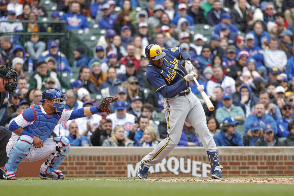 Milwaukee Brewers' Lorenzo Cain hits an RBI-ground out against the Chicago Cubs during the fourth inning of a baseball game, Thursday, April 7, 2022, in Chicago. (AP Photo/Kamil Krzaczynski)
