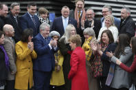 Scottish First Minister Nicola Sturgeon, centre, is greeted by newly elected candidates of Scottish National Party (SNP) during a photo opportunity as they gather outside the V&A Museum in Dundee, Scotland, Saturday Dec. 14, 2019. Sturgeon delivered a landslide election victory for the SNP, with a campaign focused on demands for a second referendum on Scottish independence, but Prime MinisterBoris Johnson has flatly rebuffed the idea of another vote. (Andrew Milligan/PA via AP)