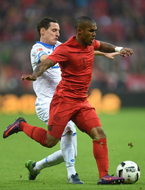 Bayern Munich's Douglas Costa (R) and Hoffenheim's Sebastian Rudy vie for the ball in Munich, southern Germany, on November 5, 2016