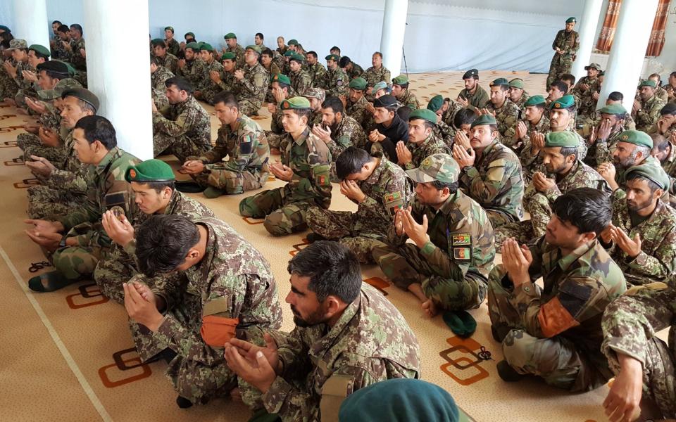 Afghan Army soldiers gather at a Mosque to pray for the departed souls of their comrades who were killed at a military in north Afghanistan, 23 April 2017. - EPA