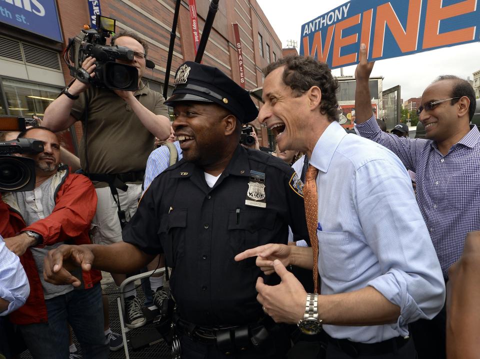 Former US Representative Anthony Weiner (C) greets voters in Harlem on May 23, 2013, after he announced he is running for New York City Mayor.