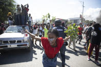 Factory workers chant anti-government slogans during a protest demanding a salary increase, in Port-au-Prince, Haiti, Thursday, Feb. 10, 2022. The workers employed at factories that produce textiles and other goods say they make 500 gourdes a day for nine hours of work and are seeking a minimum of 1,500 gourdes ($15) a day. (AP Photo/Odelyn Joseph)