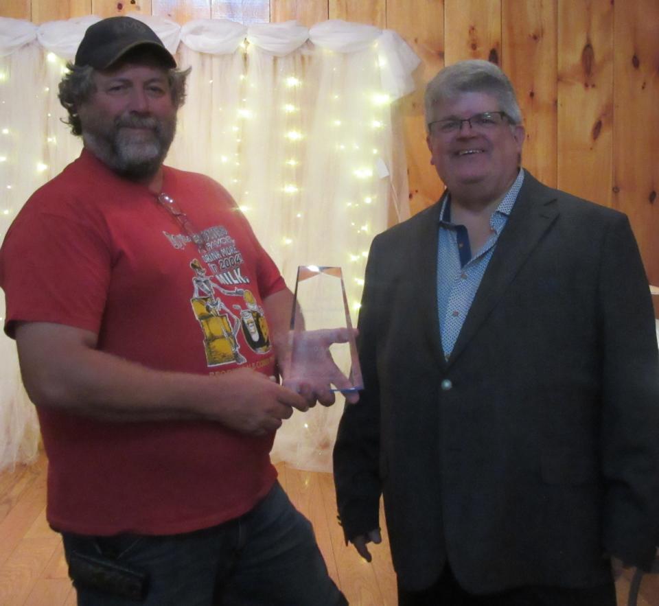 Donnie Alt (left) of Brookedale Farm accepts the 2021 Summit Award for Entrepreneurial Spirit from Chamber president Randy Crane on behalf of himself and his wife Donna (not pictured).