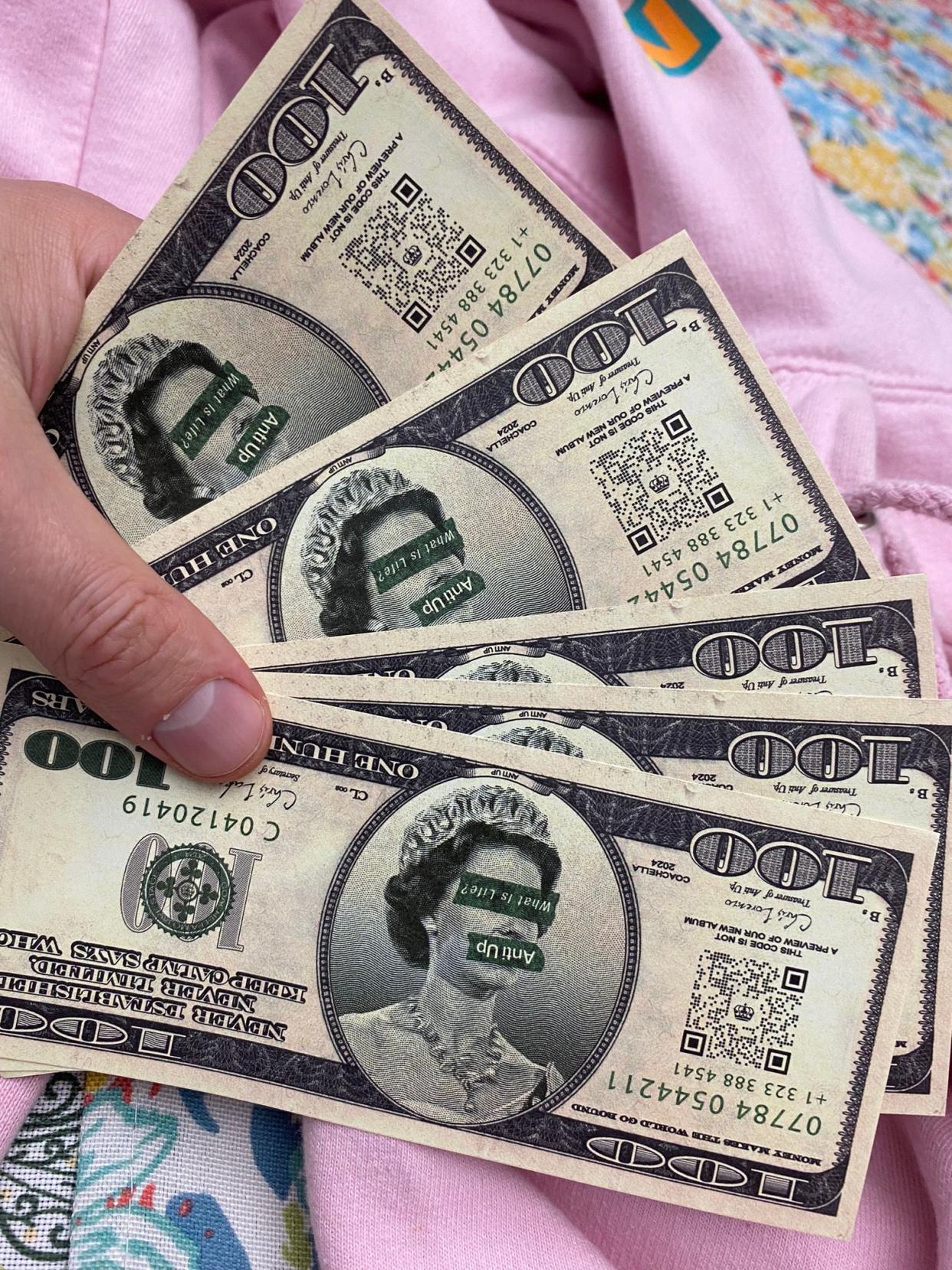 Anti Up fake 100 dollar bills at Coachella 2024 (Matthew Cooper/The Independent)