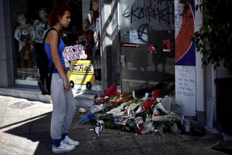 A woman stands on September 19, 2013 in front of the spot where Pavlos Fyssas was murdered, in Piraeus, Greece. Greece's prime minister on Thursday vowed to rein in the neo-Nazi Golden Dawn party after the murder of an anti-fascist singer by one of its supporters sparked nationwide outrage