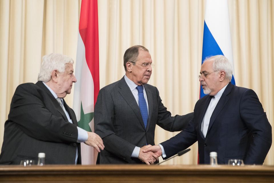 Russian Foreign Minister Sergey Lavrov, center, Iranian Foreign Minister Mohammad Javad Zarif, right, and Syrian Foreign Minister Walid Muallem, left, greet each other after a shared press conference following their talks focused on Syria in Moscow, Russia, Friday, April 14, 2017. (AP Photo/Pavel Golovkin)