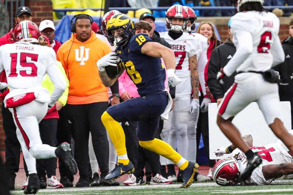 Michigan tight end Colston Loveland makes a catch against Indiana defensive back Nic Toomer during the first half at Michigan Stadium in Ann Arbor on Saturday, Oct. 14, 2023.