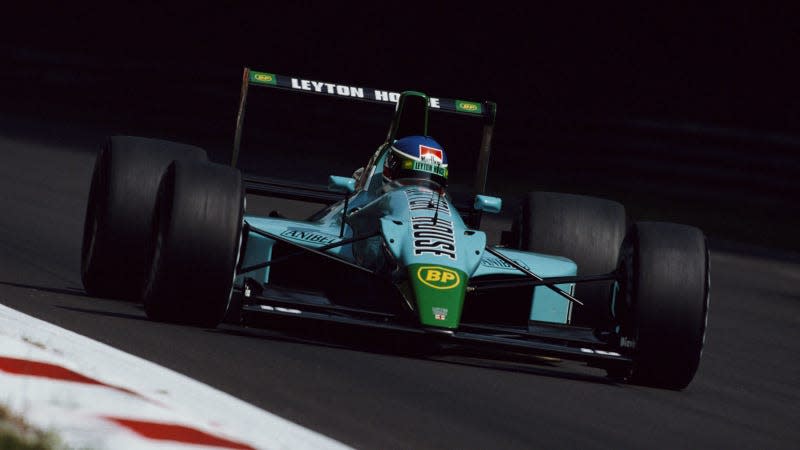 A photo of the teal Leyton House F1 car on track. 