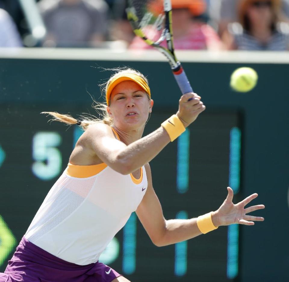 Eugenie Bouchard, of Canada, returns to Venus Williams during the Family Circle Cup tennis tournament in Charleston, S.C., Thursday, April 3, 2014. (AP Photo/Mic Smith)