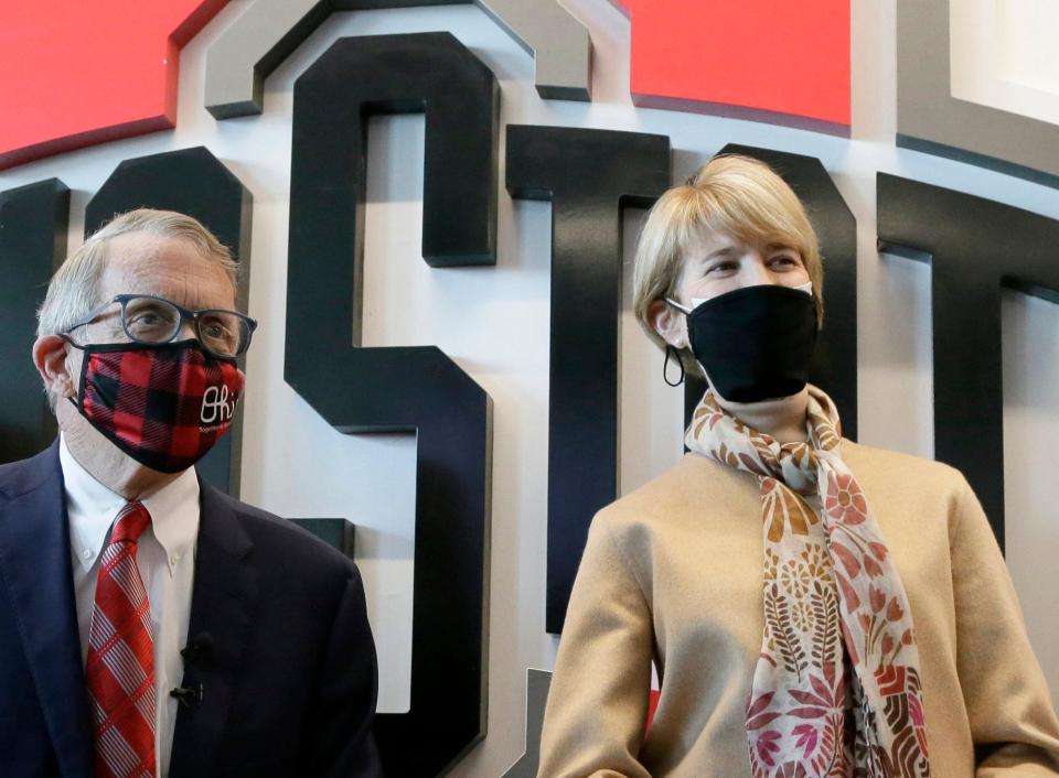 Ohio Governor Mike DeWine and Ohio State University President Dr. Kristina M. Johnson listen to questions from the media during a visit to the Columbus COVID-19 mass vaccination site at the Ohio State University's Schottenstein Center on Monday, April 5, 2021.