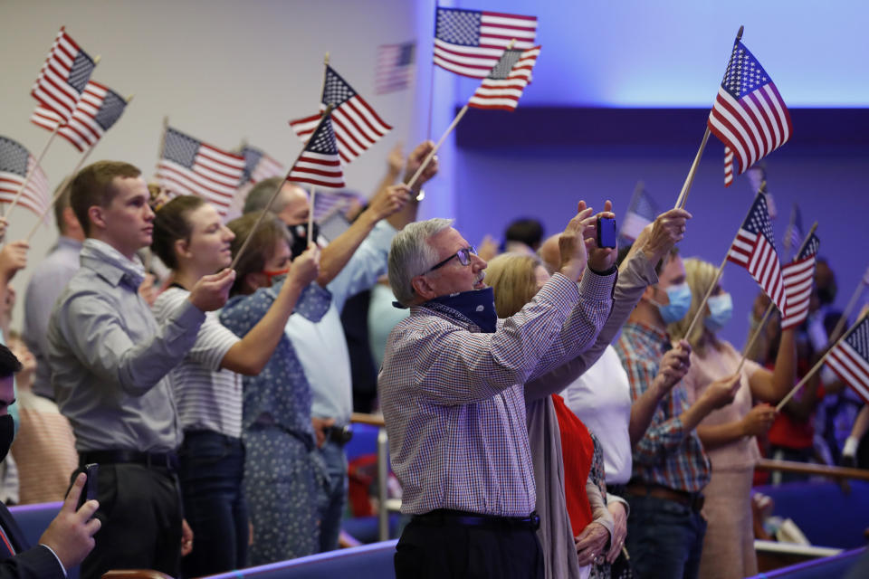 Attendees wave flags at First Baptist Church Dallas on June 28, 2020. (Photo: (AP Photo/Tony Gutierrez))