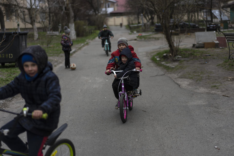 Children play in Bucha, in the outskirts of Kyiv, Ukraine, Wednesday, April 13, 2022. (AP Photo/Rodrigo Abd)