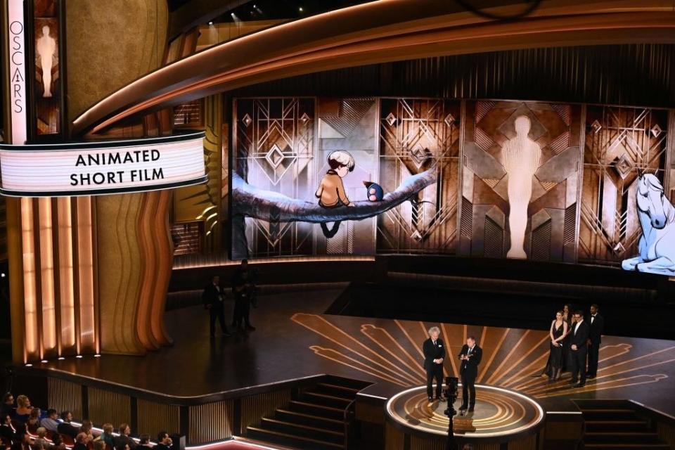 Charlie Mackesy and Matthew Freud accept the Oscar for Best Animated Short Film for "The Boy, the Mole, the Fox and the Horse" onstage