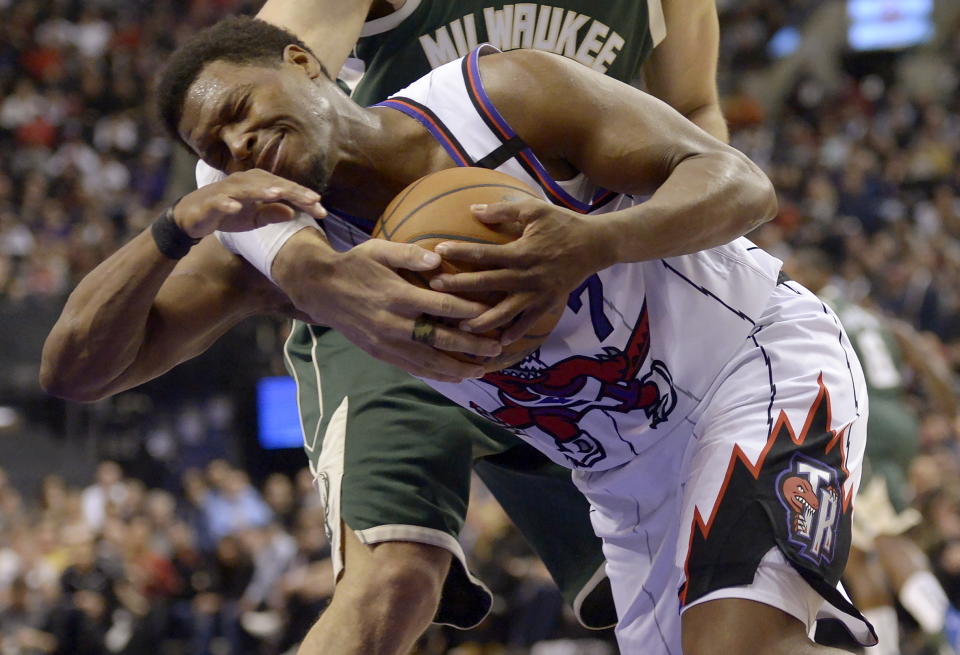 Toronto Raptors guard Kyle Lowry (7) is fouled by Milwaukee Bucks center Brook Lopez during the first half of an NBA basketball game Tuesday, Feb. 25, 2020, in Toronto. (Nathan Denette/The Canadian Press via AP)