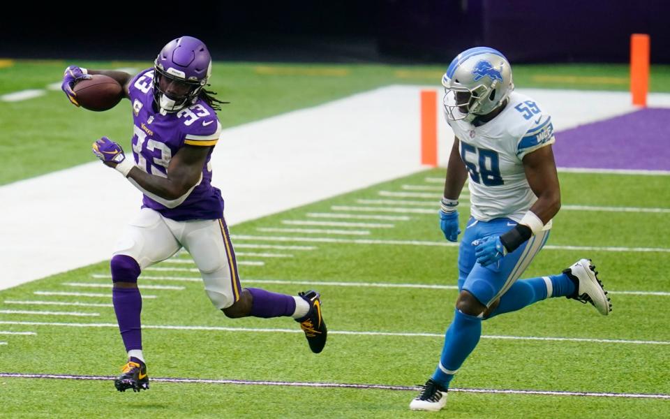 Minnesota Vikings running back Dalvin Cook (33) runs from Detroit Lions linebacker Reggie Ragland, right, during the second half of an NFL football game, Sunday, Nov. 8, 2020, in Minneapolis. - AP