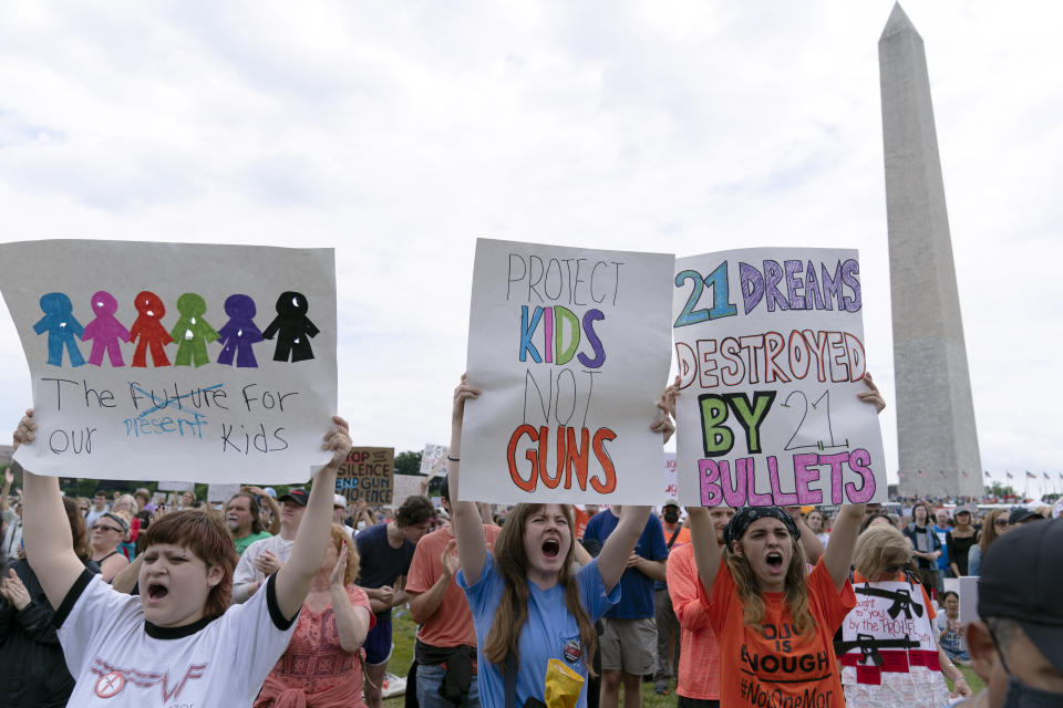 People hold signs in the second March for Our Lives rally in support of gun control in front of the Washington Monument, Saturday, June 11, 2022, in Washington. The rally is a successor to the 2018 march organized by student protestors after the mass shooting at a high school in Parkland, Fla. (AP Photo/Jose Luis Magana)