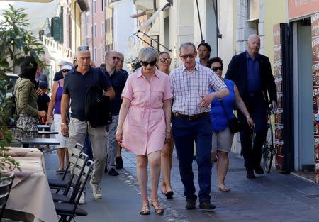 Britain's Prime Minister Theresa May walks with her husband Philip in Desenzano del Garda, by Lake Garda, northern Italy, July 25, 2017. REUTERS/Antonio Calanni/Pool