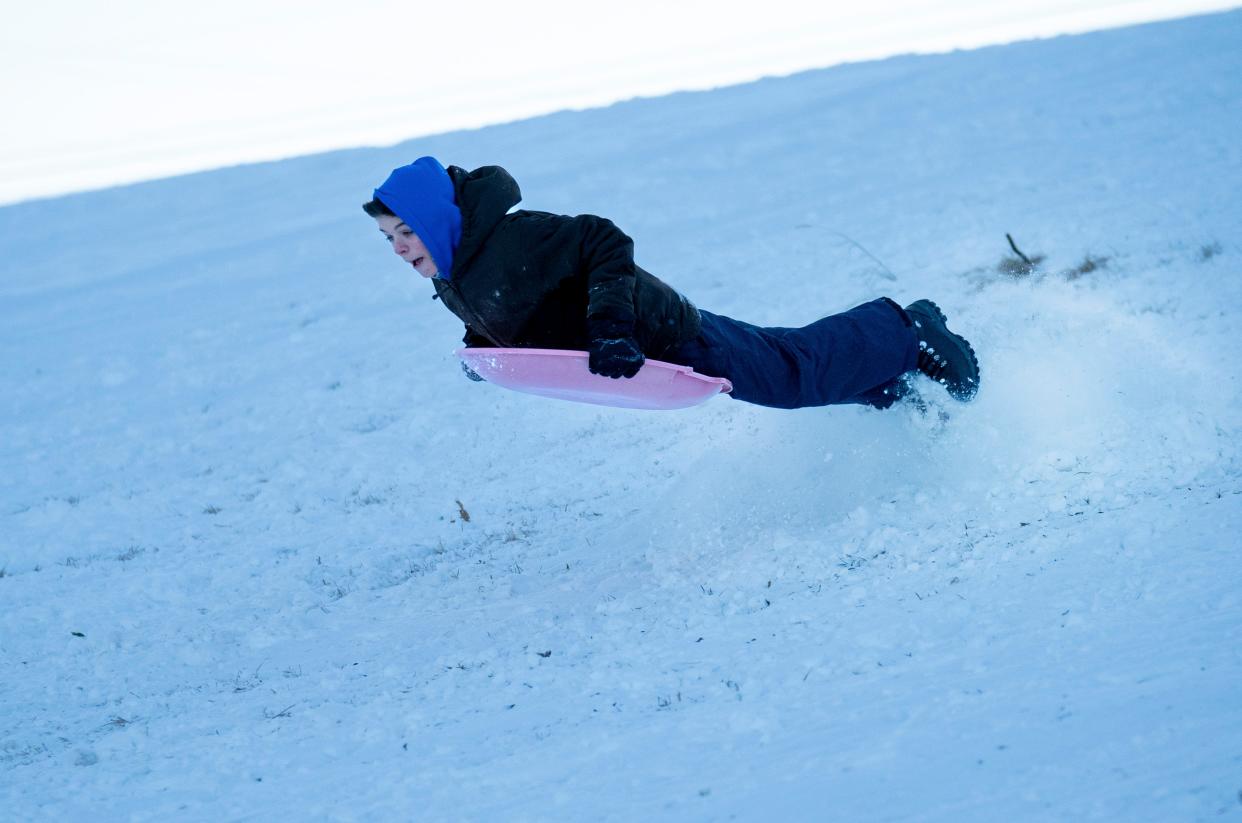 McKay Stephens, 13, of Mt. Juliet, Tenn., launches off a small snow ramp for his last air of the day at Grace United Methodist Church in Mt. Juliet, Tenn., Tuesday, Jan. 16, 2024.