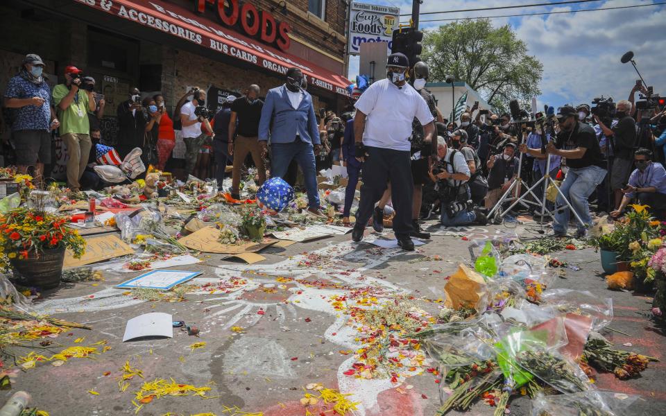 Terrence Floyd, center, at the spot in the intersection of 38th Street and Chicago Avenue, Minneapolis, Minn., where his brother George Floyd, encountered police and died while in their custody, Monday June 1, 2020. (AP Photo/Bebeto Matthews)