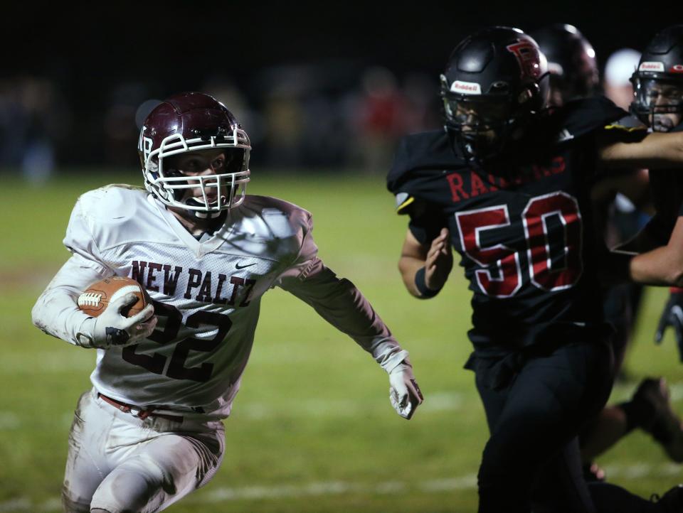 New Paltz's Justin Coiteux carries the ball away from Port Jervis' Chris Hicks during Friday's game on October 21, 2022.