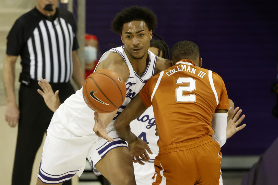 TCU forward Chuck O'Bannon Jr. (5) fouls Texas guard Matt Coleman III (2) during the second half of an NCAA college basketball game in Fort Worth, Texas, Sunday, March 7, 2021. (AP Photo/Michael Ainsworth)