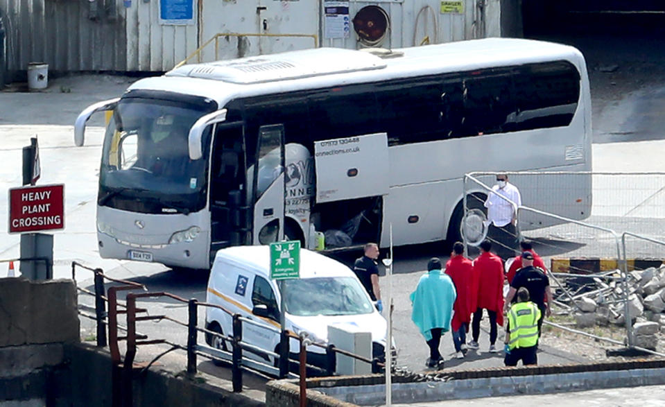 Border Force officers escort men thought to be migrants to a waiting bus in Dover, Kent, after small boat incidents in The Channel earlier this morning. Home Secretary, Priti Patel, is set to unveil details of how the UK's points-based immigration system - which will come into effect on January 1 after freedom of movement ends - will operate.