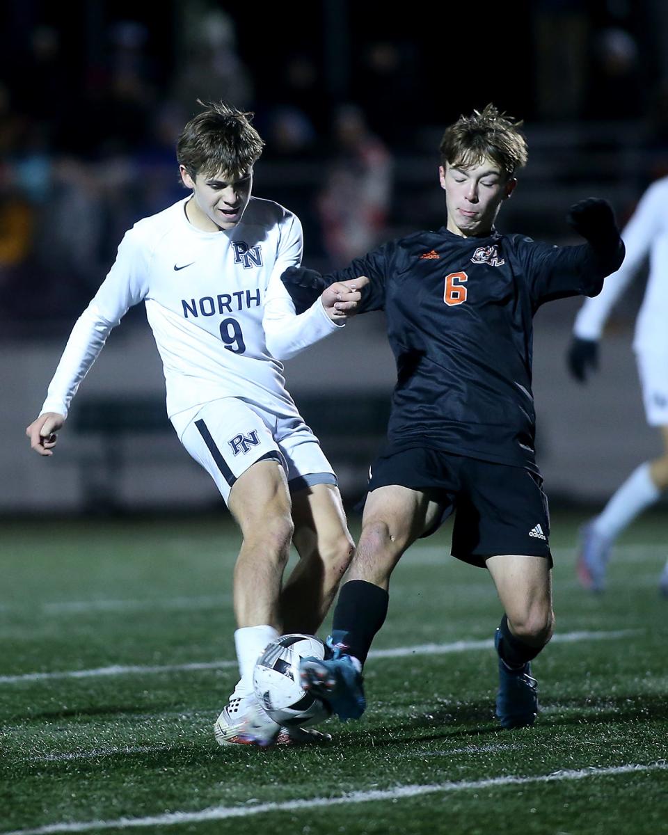 Oliver Ames's Luke Churchill steps in front to block the shot of Plymouth North's Jack Corby during second half action of the Division 2 state semifinal game against Plymouth North at Marshfield High School on Wednesday, Nov. 16, 2022. Oliver Ames won 2-0.