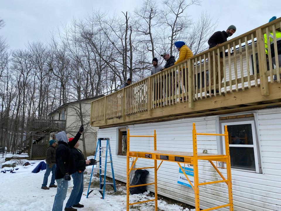 Volunteers from Sanofi, along with Habitat for Humanity, help conduct repairs on the Tobyhanna home of Anthony Johnson on Friday, Jan. 27.