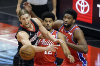 Houston Rockets forward Kelly Olynyk, left, loses the ball in front of Philadelphia 76ers forward Tobias Harris (12) and center Joel Embiid, right, during the first half of an NBA basketball game Wednesday, May 5, 2021, in Houston. (AP Photo/Michael Wyke, Pool)