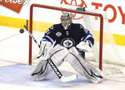 WINNIPEG, CANADA - MARCH 16: Ondrej Pavelec #31 of the Winnipeg Jets keeps his eye on the puck as it flies through the air during a game against the Washington Capitals in NHL action at the MTS Centre on March 16, 2012 in Winnipeg, Manitoba, Canada. (Photo by Marianne Helm/Getty Images)