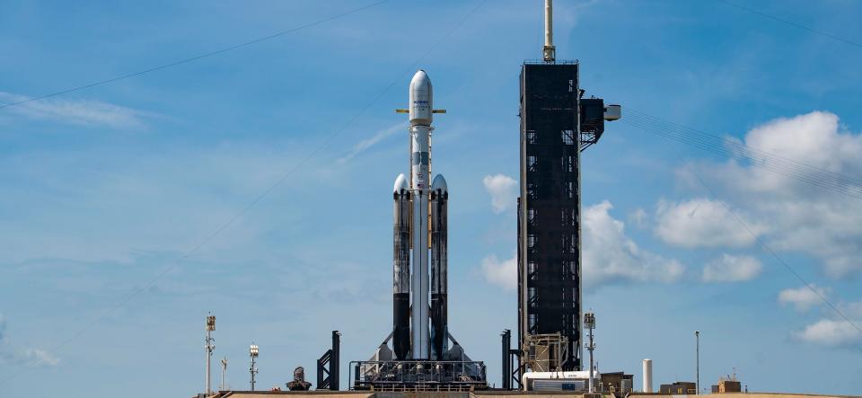 A triple-core SpaceX Falcon Heavy rocket sits on a pad at the Kennedy Space Center in Florida in July.