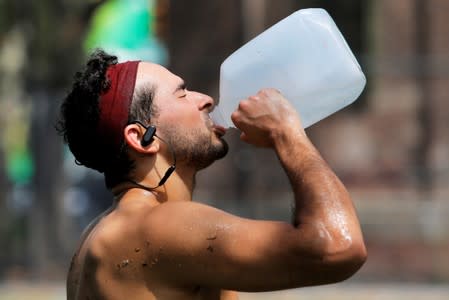 Justin Dagostino, 27, from Manhattan, drinks water while training as a heatwave continued to affect the region in Manhattan, New York City