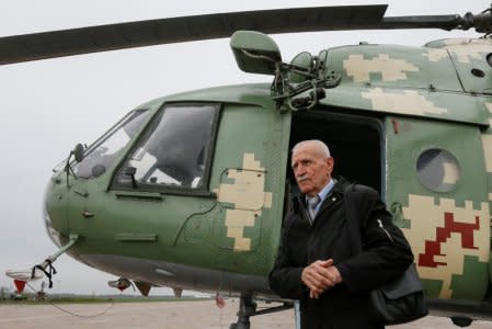 Ukrainian military pilot Mykola Volkozub, who was deployed in a team to fly a helicopter over the reactor to measure the temperature and composition of gases after the accident at the Chernobyl nuclear power plant in 1986, walks out of a Mi-8 helicopter at a military base in Kiev Region, Ukraine April 24, 2018. REUTERS/Valentyn Ogirenko