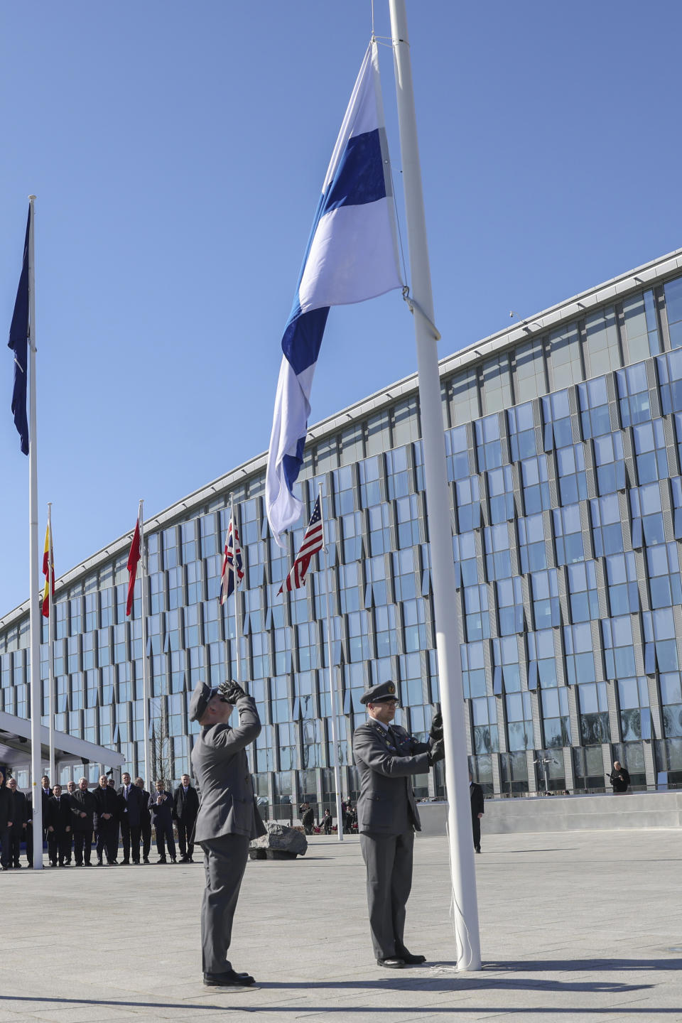 Military personnel raise the Finnish flag during a ceremony on the sidelines of a NATO foreign ministers meeting at NATO headquarters in Brussels, Tuesday, April 4, 2023. Finland joined the NATO military alliance on Tuesday, dealing a major blow to Russia with a historic realignment of the continent triggered by Moscow's invasion of Ukraine. (Johanna Geron, Pool Photo via AP)