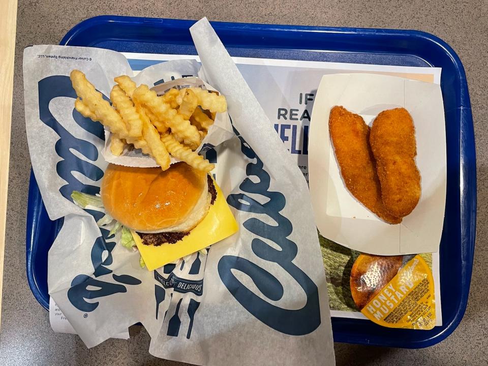 tray of burgers, fries, chicken strips, and sauce from culvers