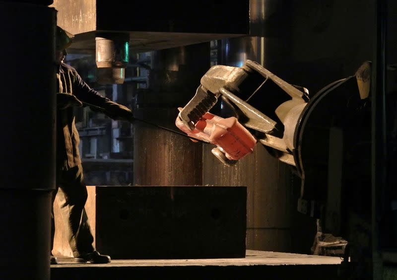 FILE PHOTO: An employee manoeuvres a titanium ingot for pressing at the VSMPO-Avisma factory in Verkhnyaya-Salda