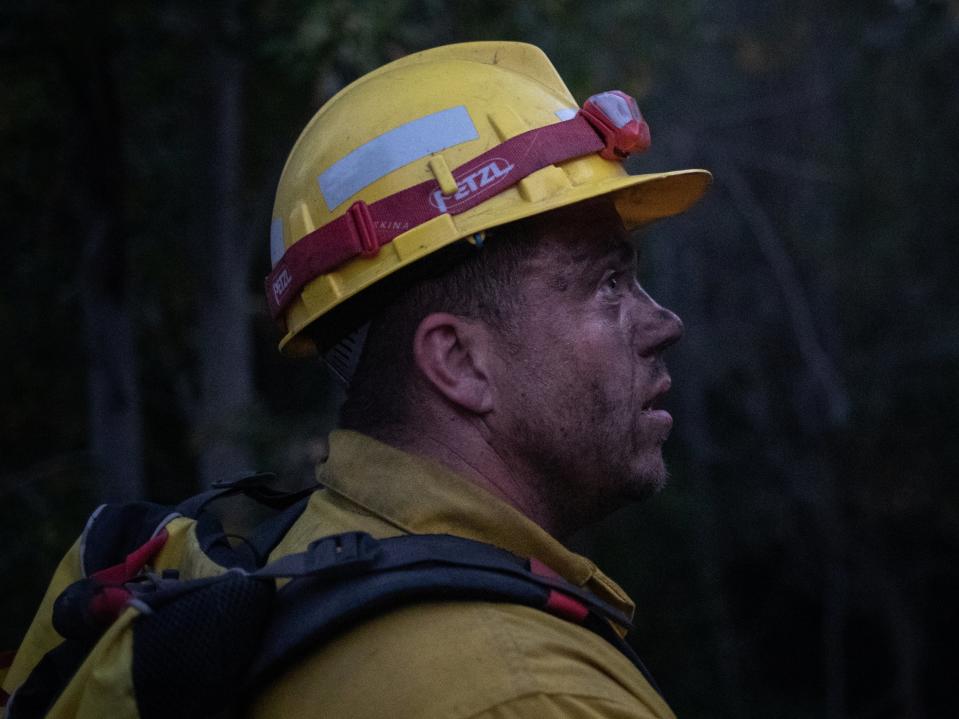 Douglas White, 28, an inmate from Warner Creek Correctional Facility, working as a firefighter, looks on as he is covered in dust and sweat, while helping to mop up hotspots from the Brattain Fire, near Paisley, Oregon, US, 19 September, 2020. REUTERS/Adrees Latif  (REUTERS)