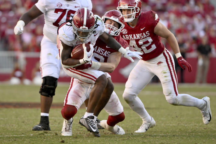 Arkansas linebacker Bumper Pool (10) tackles Alabama running back Jahmyr Gibbs during the second half of an NCAA college football game Saturday, Oct. 1, 2022, in Fayetteville, Ark. (AP Photo/Michael Woods)