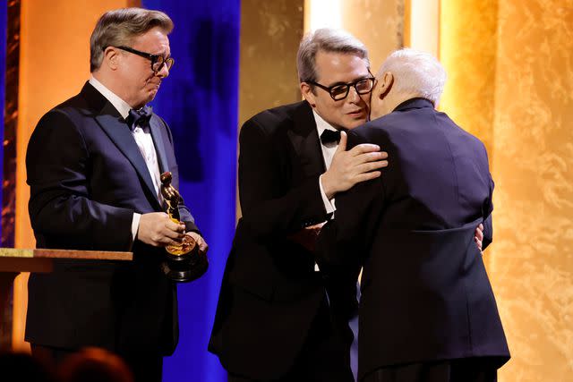 <p>Kevin Winter/Getty</p> Mel Brooks (right) receives his honorary Oscar from Nathan Lane and Matthew Broderick