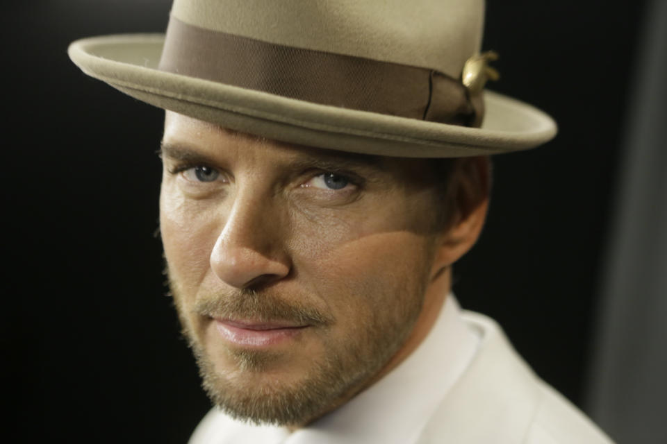 In this photo taken Thursday, March 13, 2014, English singer-songwriter and musician, Matt Goss, poses for a photo during an interview in Los Angeles. Goss is formerly the lead singer of 1980s pop group Bros, which included his twin brother, Luke Goss as drummer, and Craig Logan as bass player. He is currently performing a headline show at Caesars Palace in Las Vegas. (AP Photo/Damian Dovarganes)