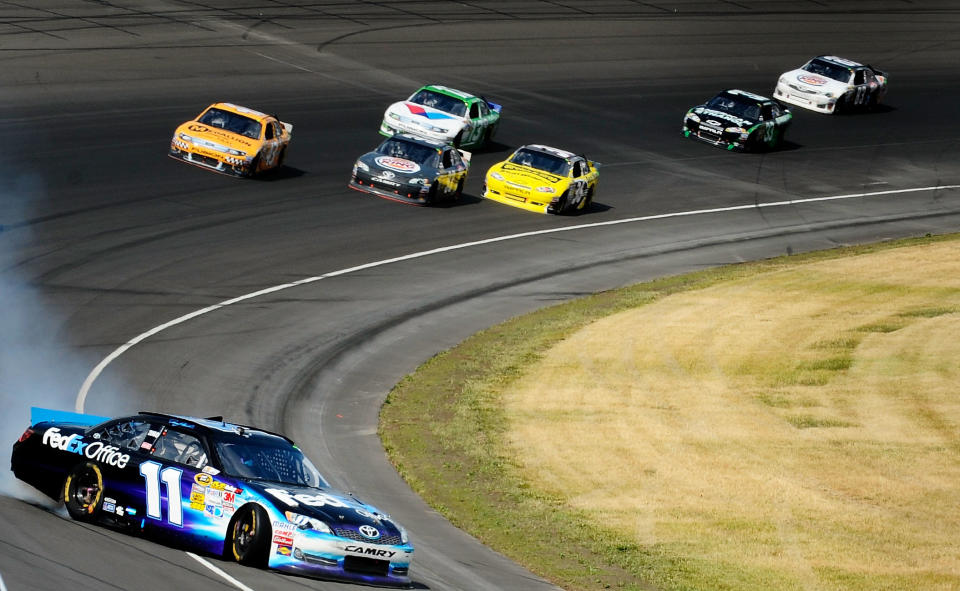 BROOKLYN, MI - JUNE 17: Denny Hamlin, driver of the #11 FedEx Office Toyota, is involved in an incident during the NASCAR Sprint Cup Series Quicken Loans 400 at Michigan International Speedway on June 17, 2012 in Brooklyn, Michigan. (Photo by Jared C. Tilton/Getty Images)