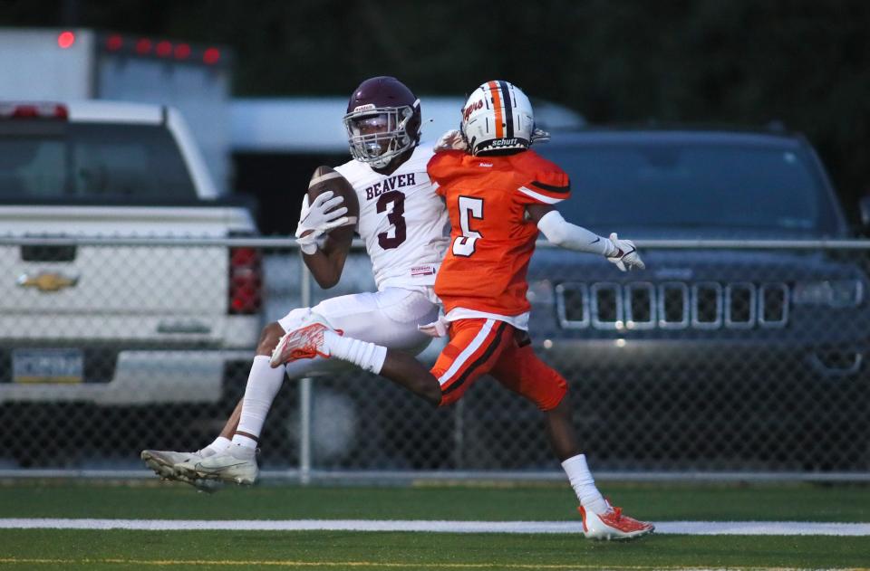 Beaver's Gerrell Leeper (3) goes airborne in an attempt to haul in a pass for a touchdown while being covered by Beaver Falls Di'Nari Harris (5) during the first half Friday night at Reeves Stadium in Beaver Falls.